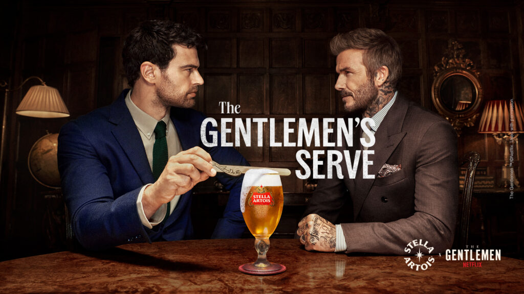 Stella Artois x The Gentlemen campaign image: two men in suits facing each other across a pub table over a chalice of beer